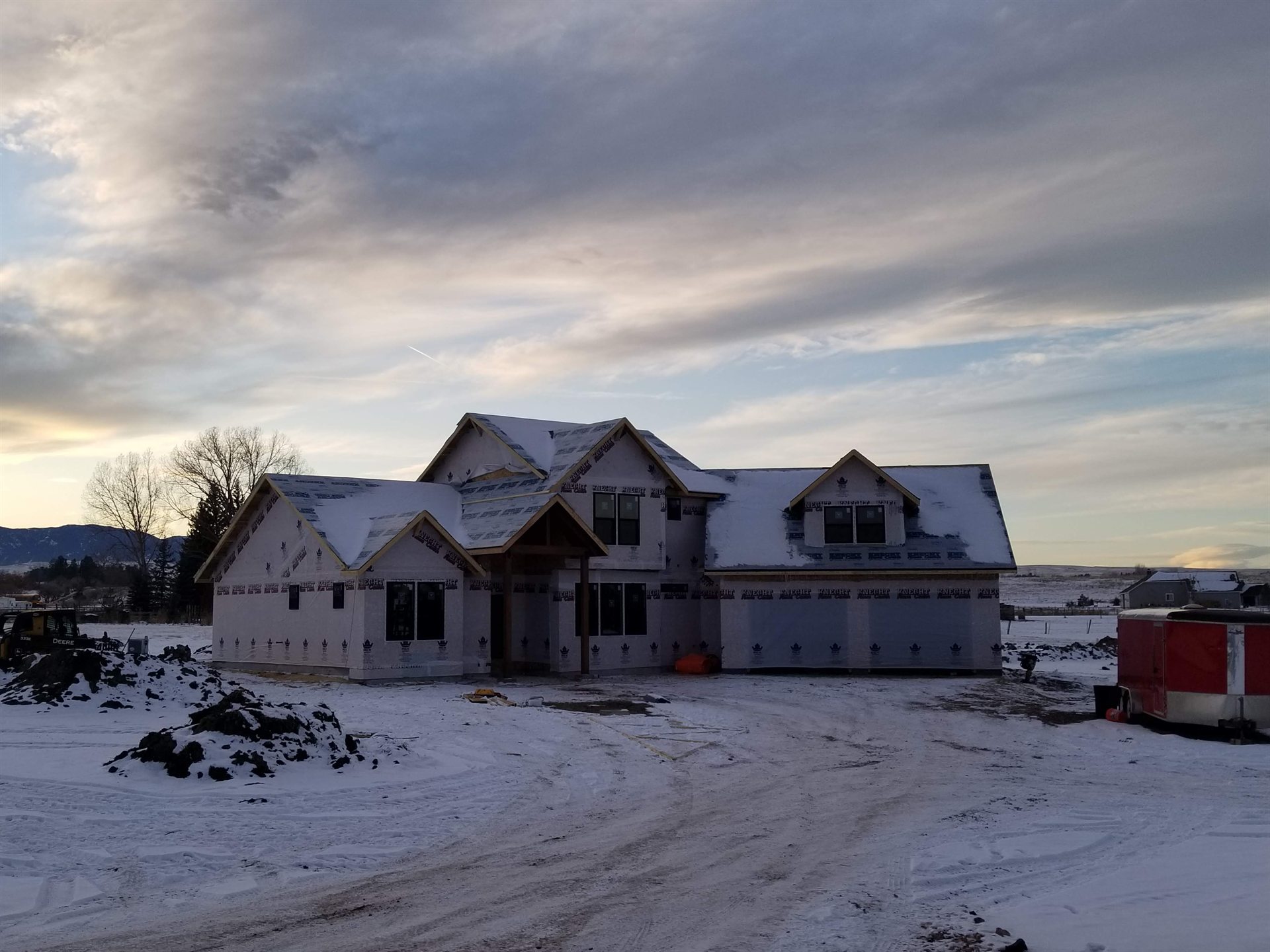 Build It Brothers crew framing a home at sunrise
