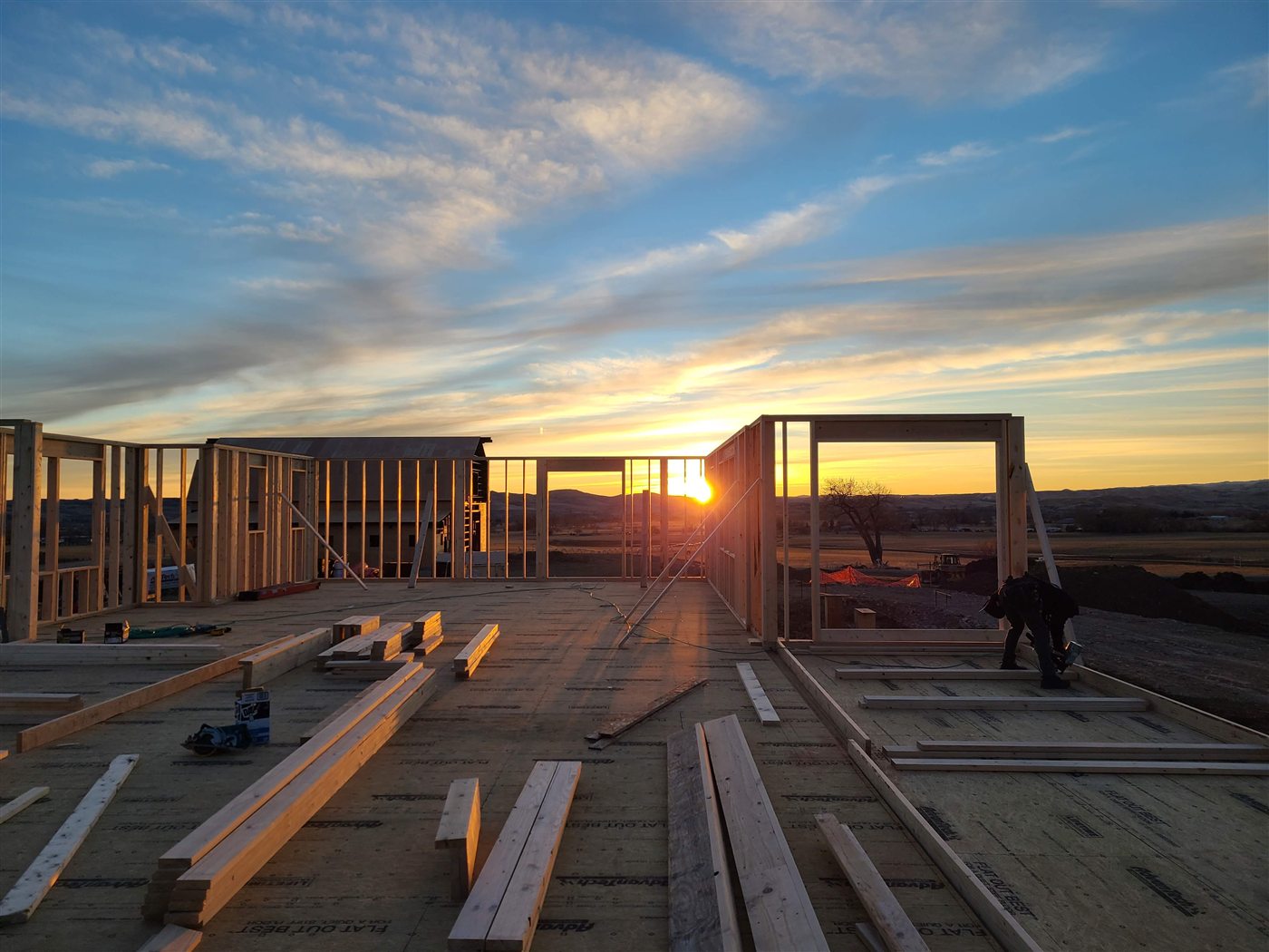 Build It Brothers crew framing a home at sunrise